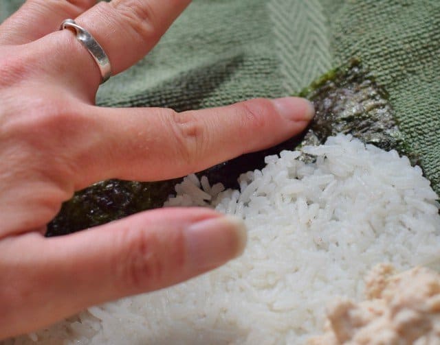 Lightly run water on open edge of nori for homemade spicy tuna rolls