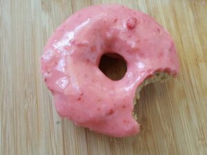 Homemade strawberry donuts recipe with a bite missing