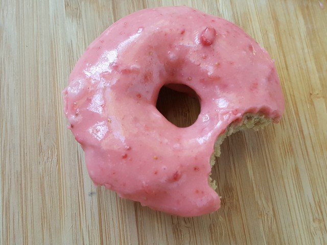 Homemade strawberry donuts recipe with a bite missing