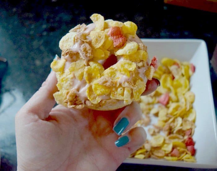 Dip glazed donut into cereal