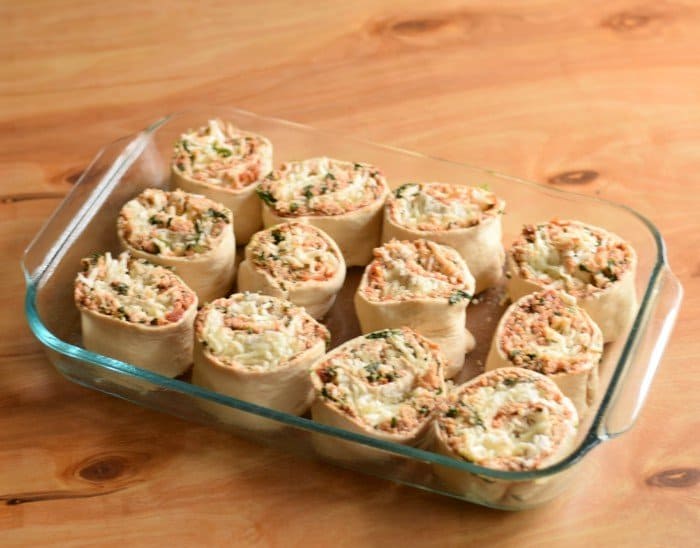 Add cut pizza rolls to greased glass baking dish