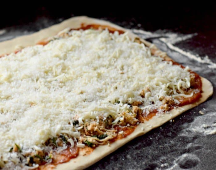 Layer toppings on dough to make delicious pizza rolls