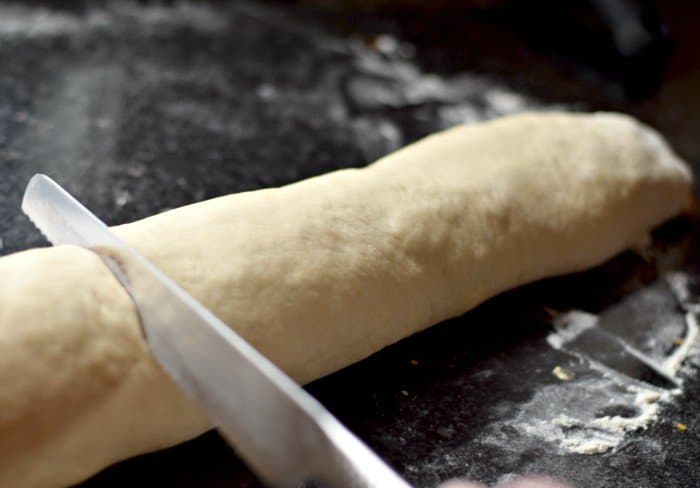 Use a serrated knife to cut pizza rolls into slices