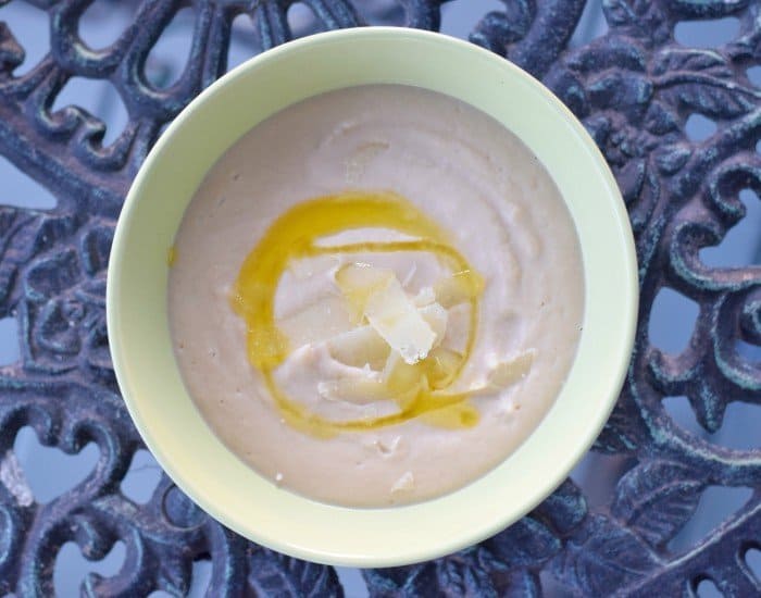 Bowl of Tuscan bean soup naturally gluten free and drizzle with olive oil