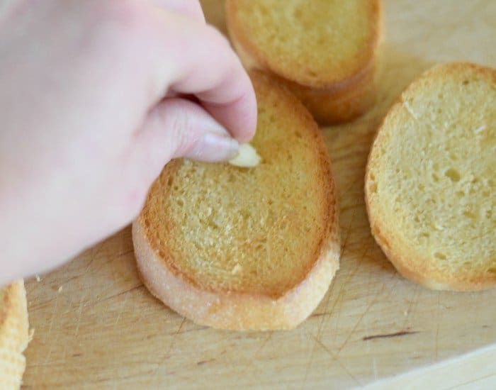 Rub crostini with garlic clove