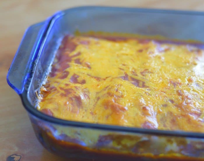 Baked cheesy chicken enchiladas with flour tortillas