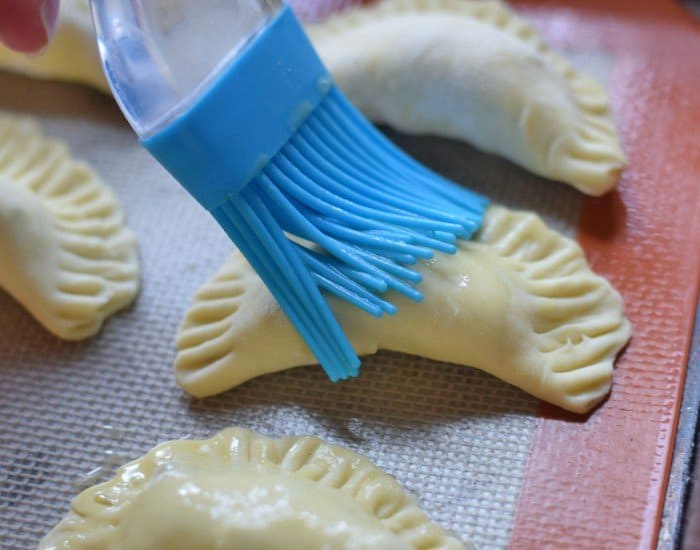 Brush tops of empanadas with egg wash