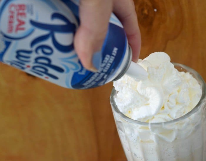 Add whipped cream to the top of the cake batter frappe