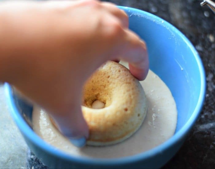 Dip homemade doughnut into glaze