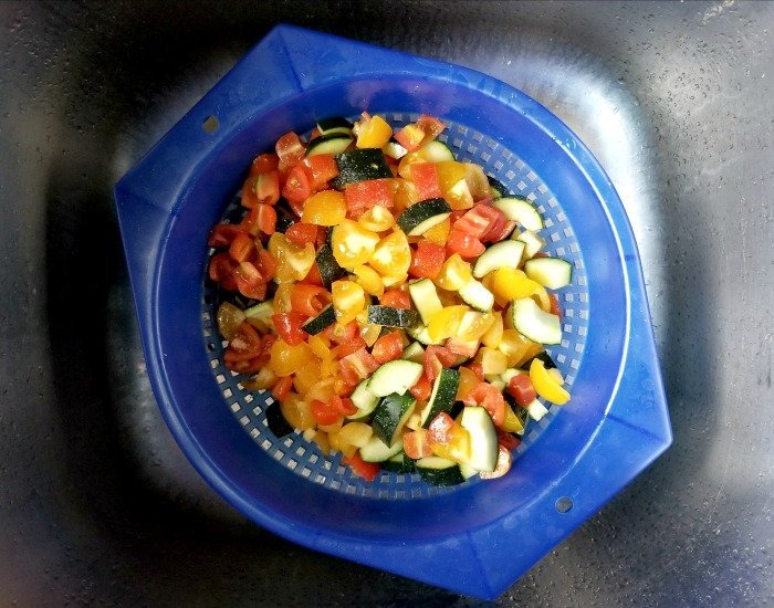 Drain chopped veggies in the sink in a colander