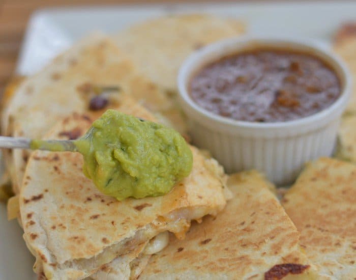 Add guacamole to carnitas stuffed quesadillas