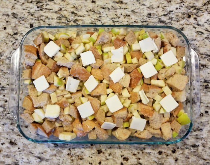 Add pats of butter to caramel apple bread pudding