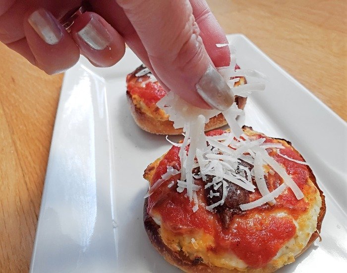 Add Parmesan cheese to lasagna pizzas