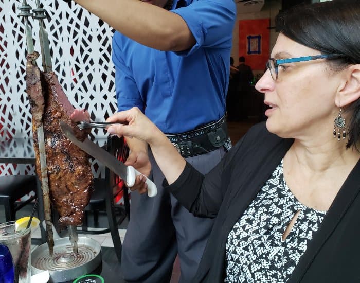 Serving meat at Texas de Brazil