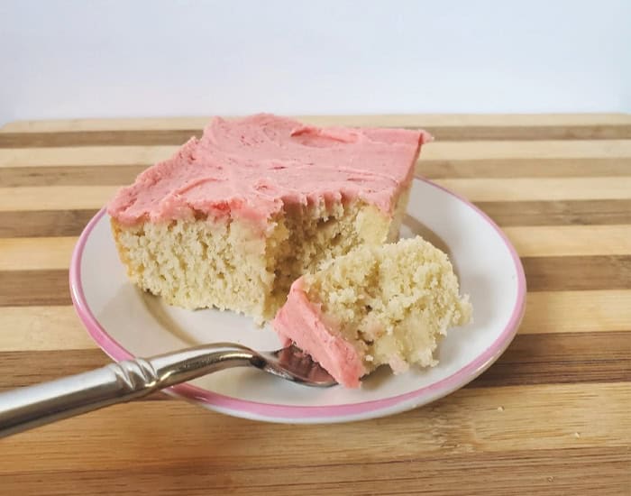 Bite of cake with strawberry frosting