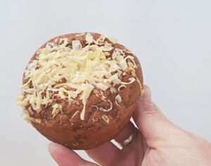 Holding homemade asiago cheese bagel
