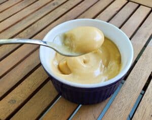 Bite of butterscotch pudding on a spoon.