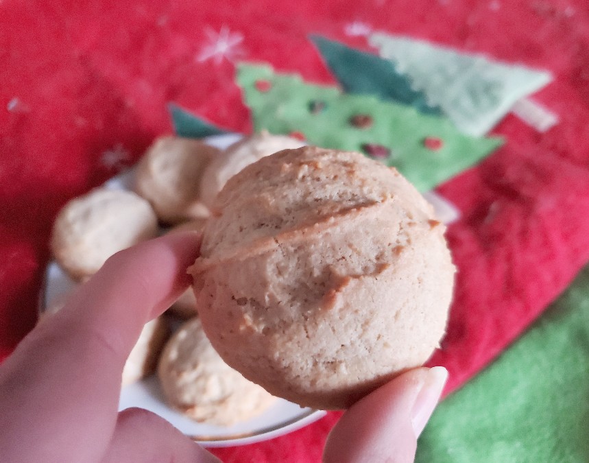 Holding a christmas cookie over a plate