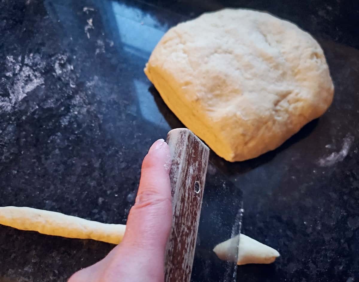 Cutting gnocchi rope into pieces