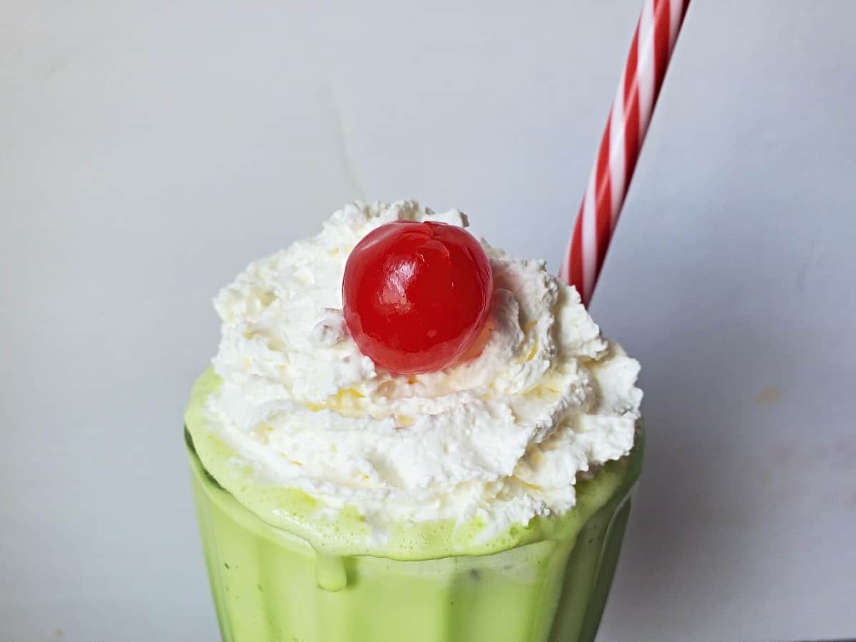 Closeup of a homemade McDonalds shamrock shake in a milkshake glass.