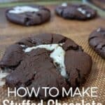 Chocolate cookies on a baking sheet with text how to make stuffed chocolate cookies.