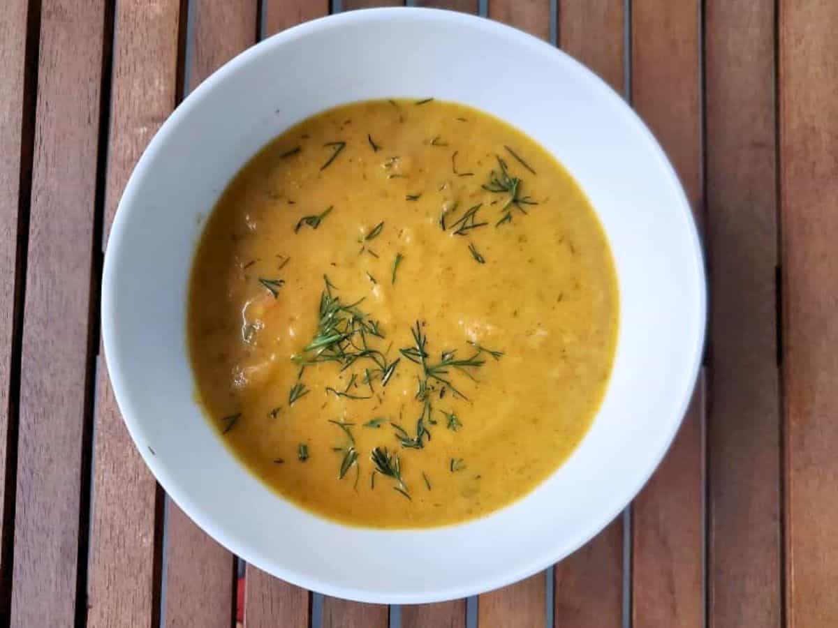 Image shows bowl of irresistible carrot ginger soup.