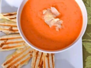 Image shows irresistible bowl of tomato basil soup.