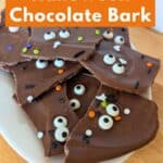 Image shows a Plate of Halloween bark with text how to make Halloween chocolate bark.