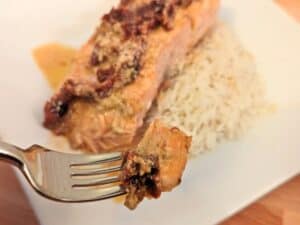 Image shows a forkful of creamy sun-dried tomato salmon.
