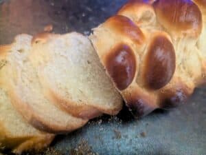 Image shows sliced challah bread.