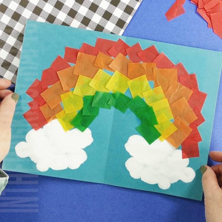 Easy Rainbow Craft made with squish painted clouds and tissue paper rainbow
