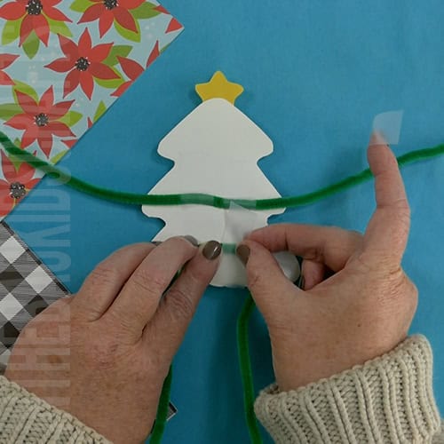A completed Christmas tree craft made with green paper, colorful beads, pipe cleaners, and a star topper, perfect as an easy craft for kids and a festive Christmas tree craft. step 7 adding the pipe cleaner arms and legs 