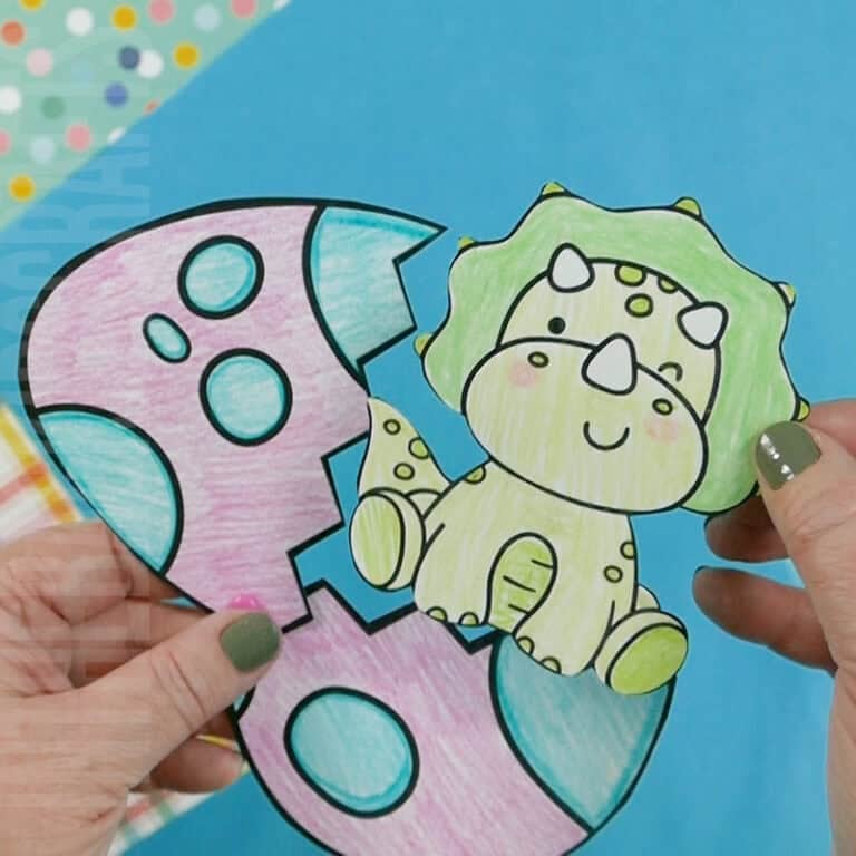 A colorful dinosaur egg craft featuring a baby triceratops hatching from a decorated egg, perfect as a free printable craft for kids to enjoy.