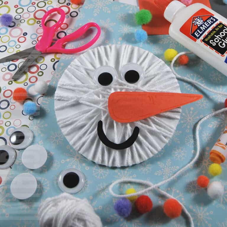 A fun snowman craft made with yarn, googly eyes, and paper materials, perfect as a winter craft and an easy craft for kids.