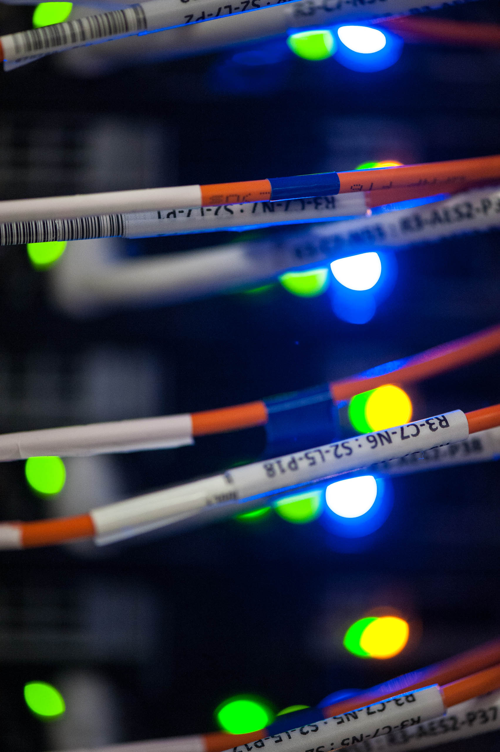 March 14, 2013 - Detail of wiring in the high performance computing (HPC) data center at NREL's Energy Systems Integration Facility.  Initially, the HPC data center will house a petascale computing capability (one million billion calculations per second) and provide room for future systems that enable large-scale modeling and simulation of novel materials, biological and chemical processes, and fully integrated systems that would be too expensive, or even impossible, to study by direct experimentation.  (Photo by Dennis Schroeder / NREL)