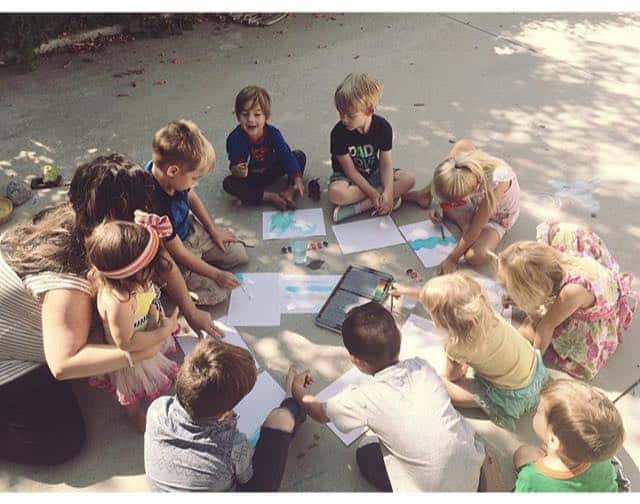 homeschooling co op five in a row children painting pictures on pavement 
