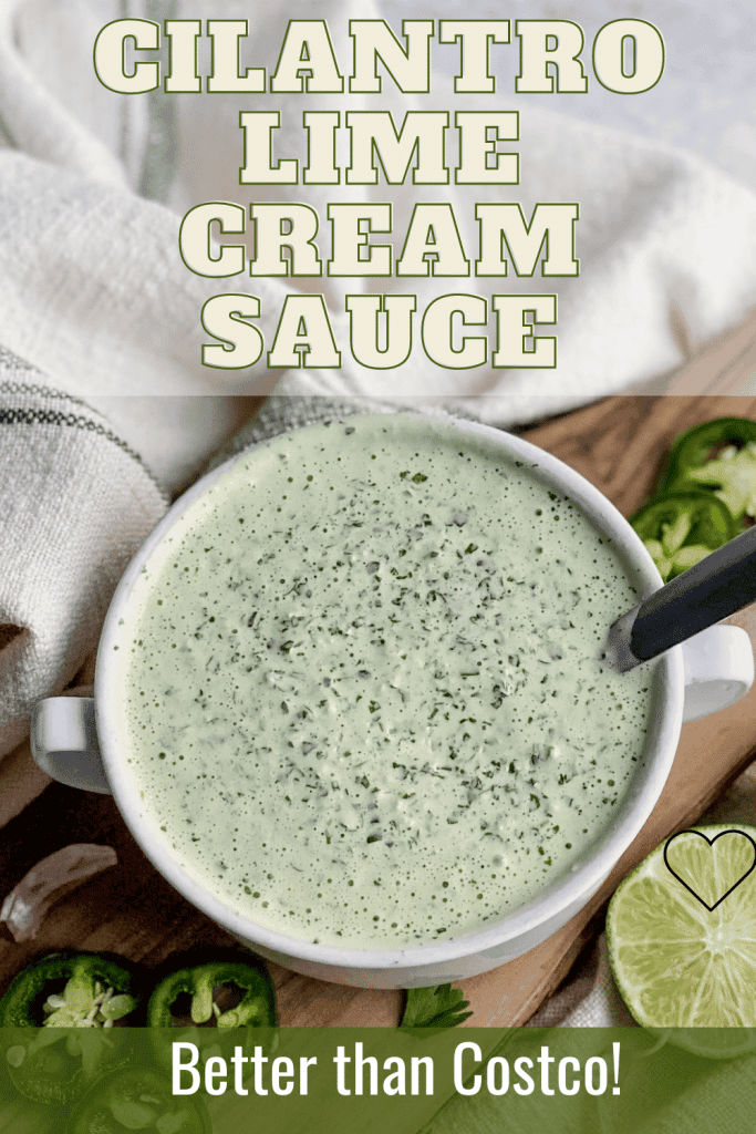 cilantro lime cream sauce in a bowl on the table with limes and jalapeños near by 