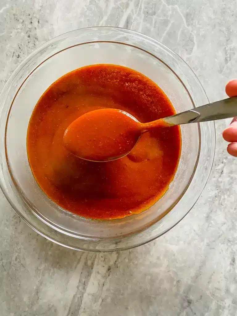 spoonful of gluten free enchilada sauce made at home with simple ingredients