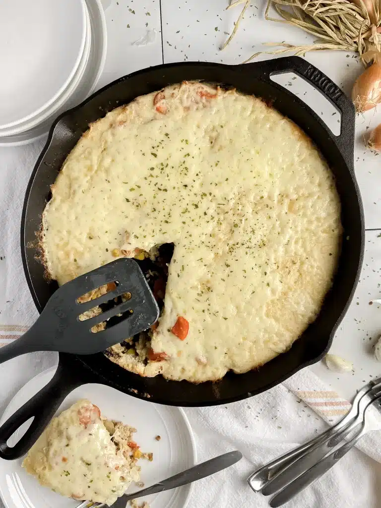 overhead shot of gluten free sourdough skillet on a table with plates and forks nearby