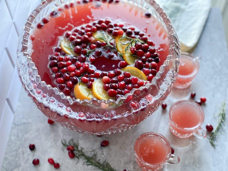 large punch bowl with red Christmas punch with cranberry orange slice ice ring