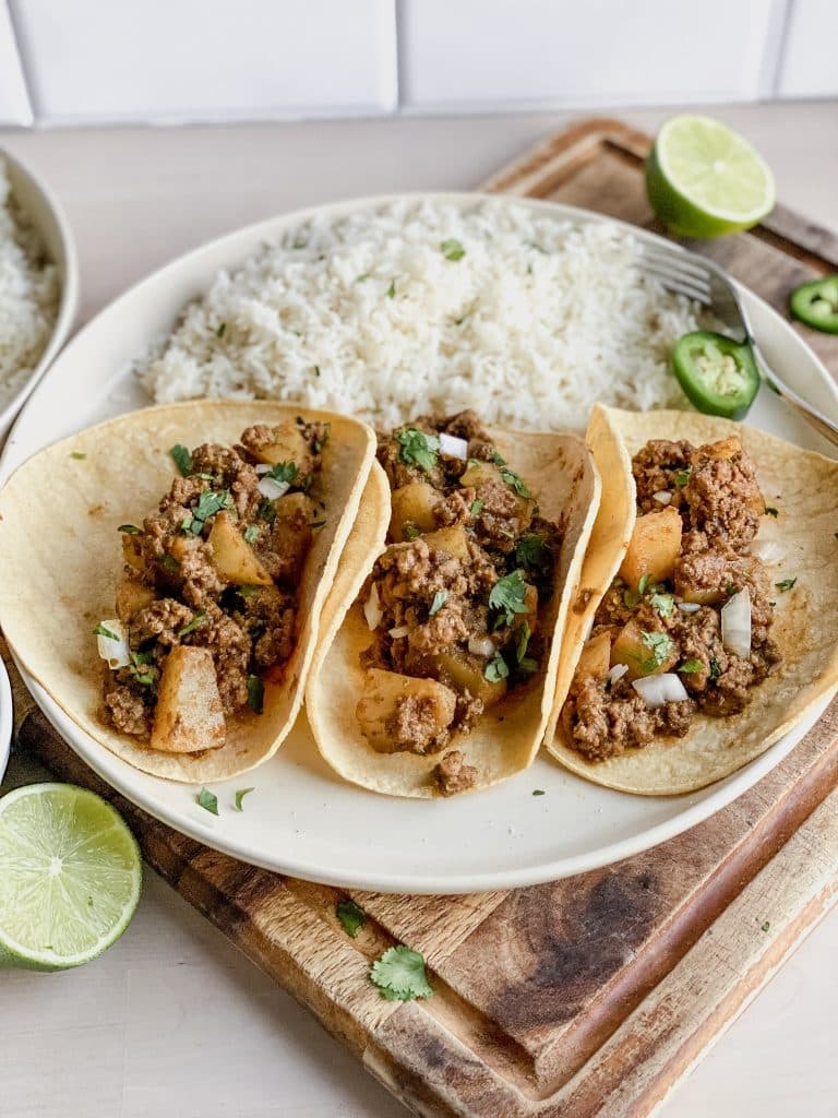 Mexican Picadillo filled tacos with lime and cilantro rice