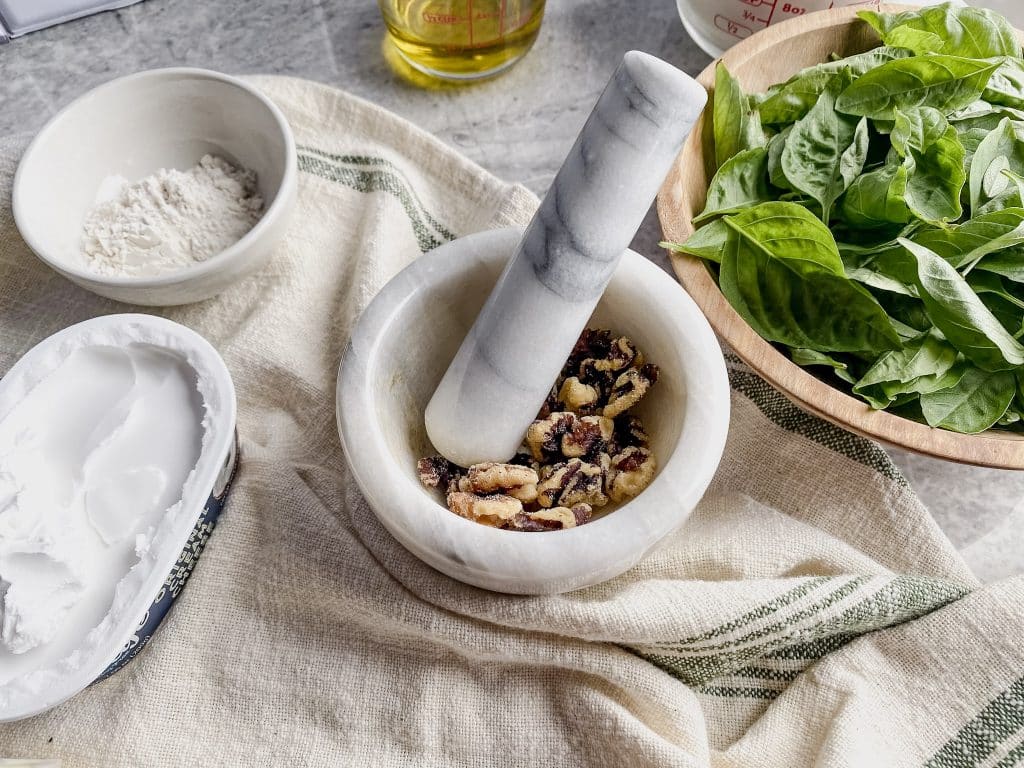 Pestle and Mortar with walnuts for making homemade pesto 