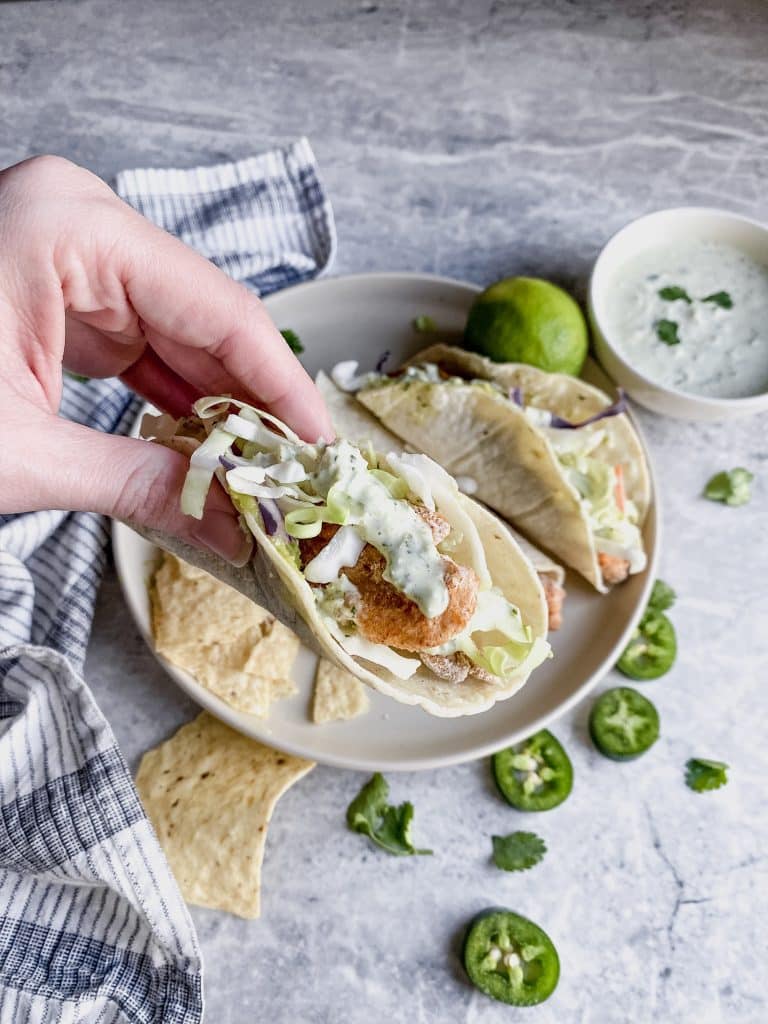 taco of gluten free fried fish tacos with cilantro lime cream sauce