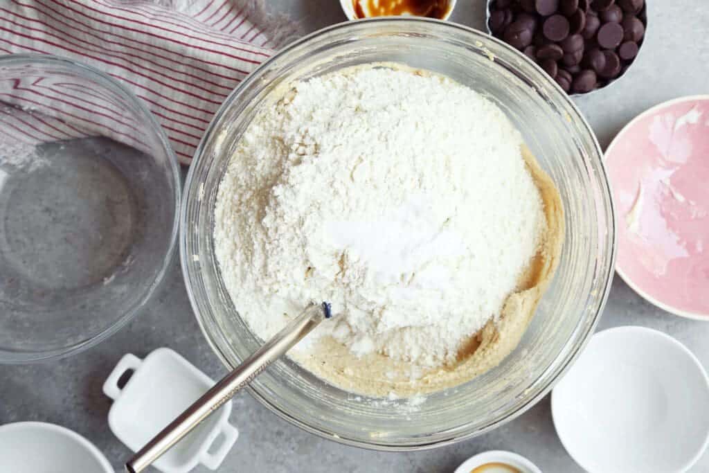 Adding dry ingredients to brown butter chocolate chip cookies.