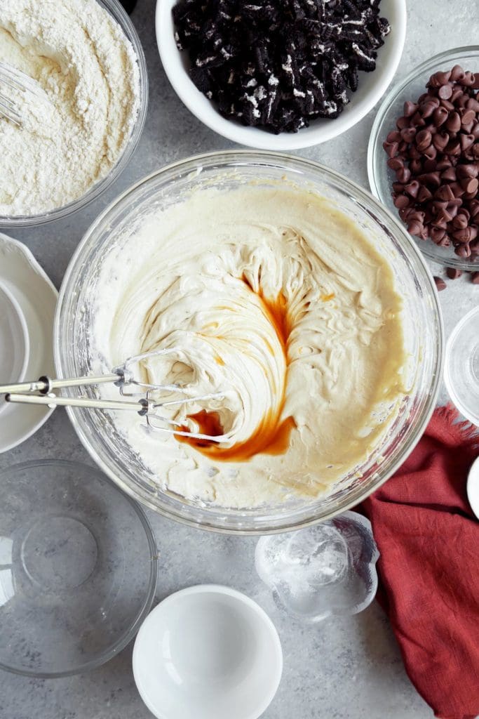 Vanilla extract beaten into cookie batter in a bowl. 