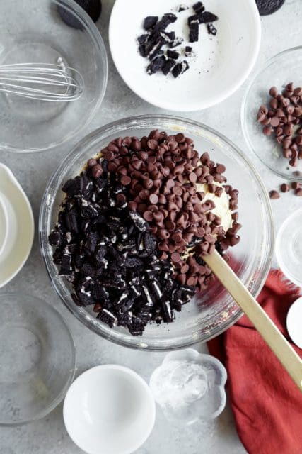 Chocolate chips and crumbled oreos poured into a batter to make the best chocolate chip cookie recipe