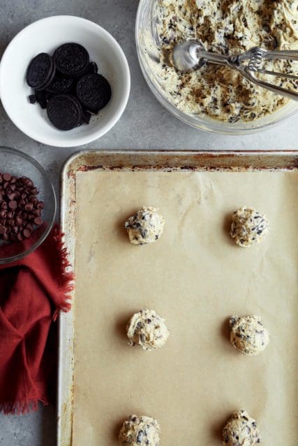 Best Chocolate Chip Cookie dough balls on a baking sheet with parchment paper
