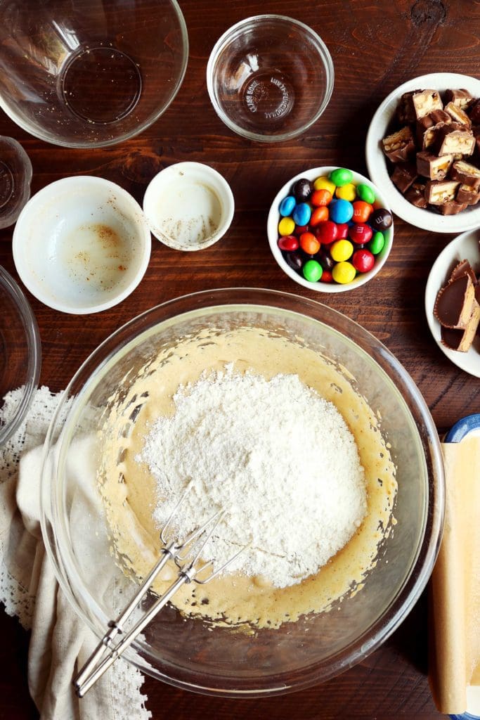 flour in a bowl with creamed eggs and sugar