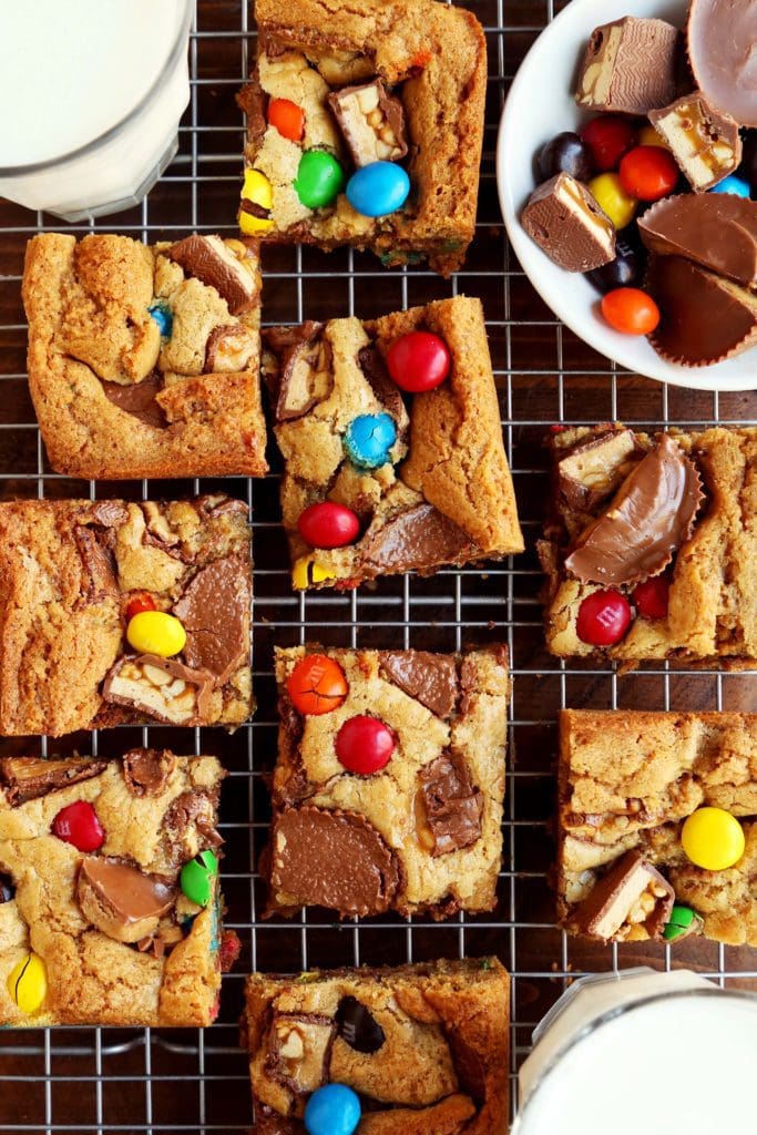 Sliced candy bar blondies on a cooling rack