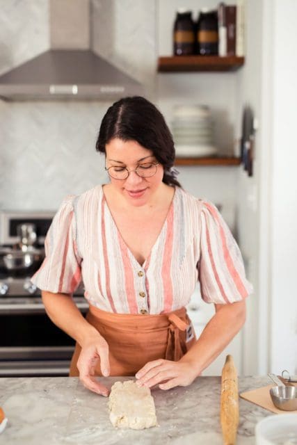 Joy the Baker pressing pie crust into rectangle.